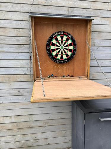 a dart board hanging from a wall with a dartboard at Time 4 Time in Roesbrugge-Haringe