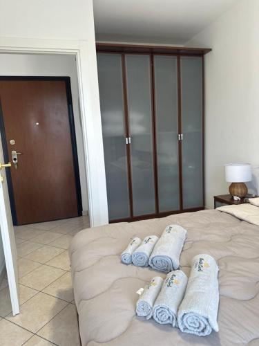 a bedroom with a bed with three towels on it at Montecarlo house vacation in Luino