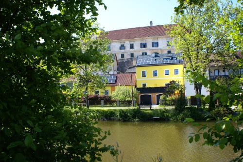 a building next to a body of water at Top Appartements Taufner in Waidhofen an der Thaya