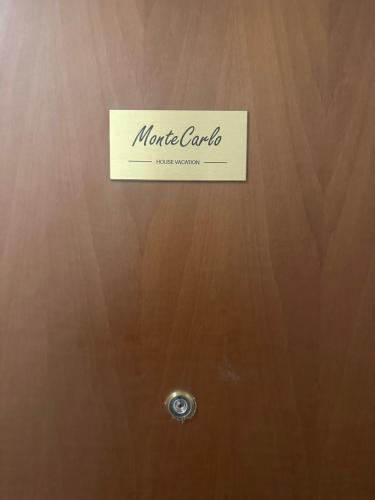 a sign on top of a wooden door at Montecarlo house vacation in Luino