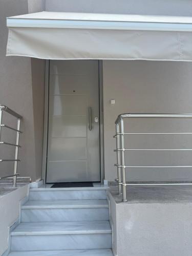 a staircase with a glass door in a building at LIV Aspropyrgos in Asprópirgos