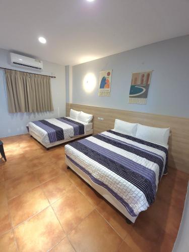 a hotel room with two beds in a room at moon ludao minsu2 in Green Island