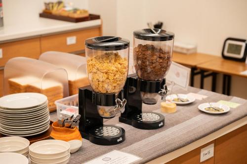 a counter with two blenders filled with food at Miyajima Guest House Mikuniya in Miyajima