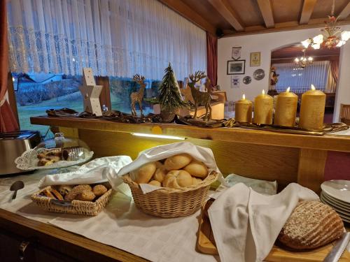 a counter with baskets of bread and other foods on it at Pension Grein in Pfunds