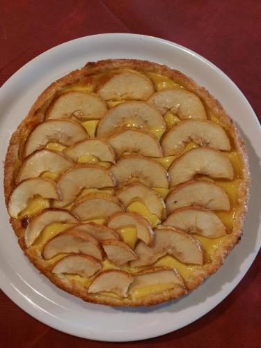 a apple pie on a white plate on a table at Agriturismo Roccamaia in Pievebovigliana