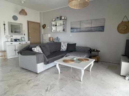 a living room with a couch and a coffee table at J&J Seaview Apartment in Ofrínion