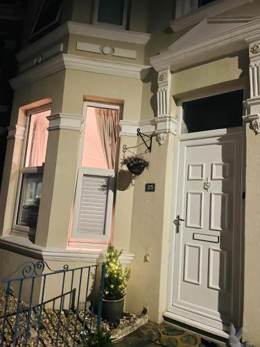 a house with a door and a christmas tree in front at Peverell Loft Retreat in Plymouth