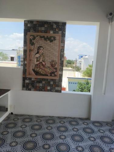 a mosaic picture of a woman on a wall at Raja Accommodation in Kovilpatti
