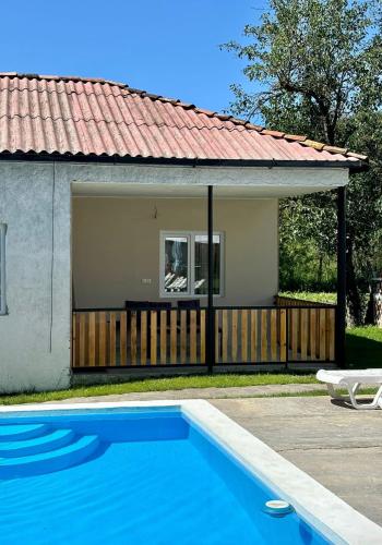 a house with a swimming pool in front of a house at Cozy Family Home 