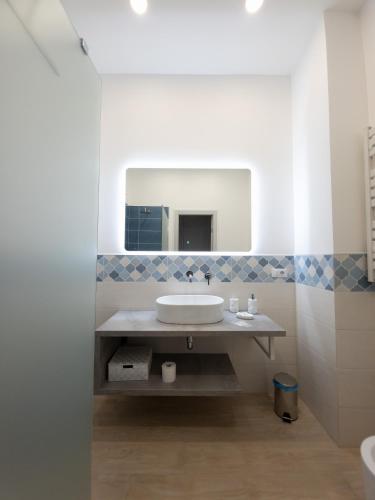 a bathroom with a sink and a mirror at Light Charme, Sea Light Apartment a due passi dalla PIAZZA DUOMO in Terrasini