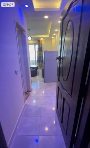 a hallway with a door in a room with lights at Dalina الساحل الشمالي قدام مراسي in El Alamein