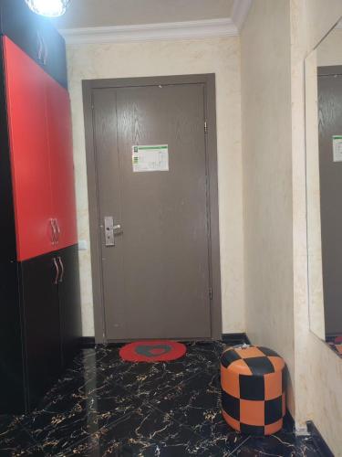 a door in a room with a red circle on the floor at Spacious studio 5 min to the sea in Batumi