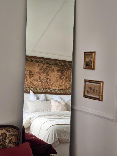 a mirror in front of a bedroom with a bed at La dolce vita Giove apartment in Giove