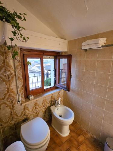 a bathroom with a toilet and a sink at La dolce vita Giove apartment in Giove