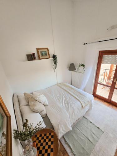 a bedroom with a bed in a room with a window at La dolce vita Giove apartment in Giove
