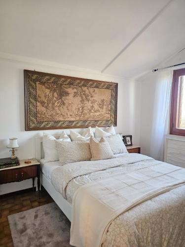 a bedroom with a large bed with a tapestry on the wall at La dolce vita Giove apartment in Giove