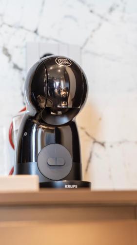 a black coffee maker sitting on a shelf at Keslin Premium Seaside Apartments in Vlorë