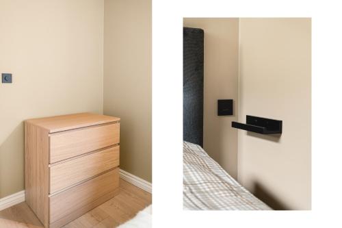 a bedroom with a wooden dresser next to a mirror at Odda Trolltunga Atmosphere in Odda