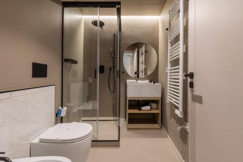 a bathroom with a shower and a toilet and a sink at Domus Terravecchia in Agrigento