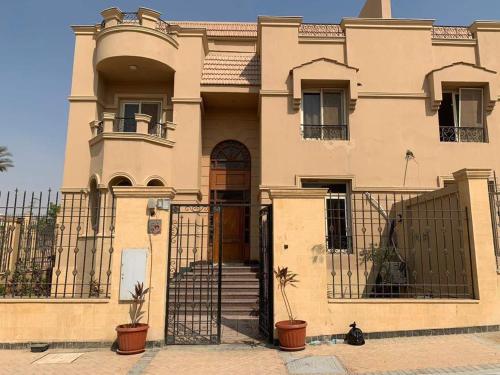 a large house with a gate in front of it at Villa waterway 2 in Cairo