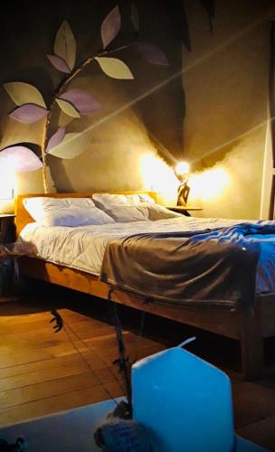 a bedroom with a bed with a painting on the wall at B&B EcoAntico casa in paglia in Maiolo