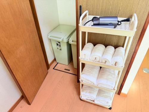 a towel rack with a hair dryer on it next to a toilet at 西山ハウス204 in Nagasaki