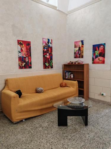 a living room with a couch and a table at La Casa delle Zie in Maglie