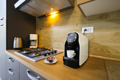 a coffee machine sitting on a counter next to a stove at RESIDENCE LA TORRE appartamento FLOWER free parking in Padova