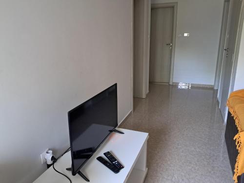 a flat screen tv sitting on a table in a bedroom at Apartman EXIT-TVRĐAVA in Petrovaradin