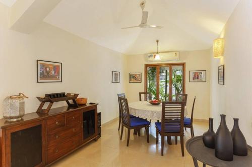 a dining room with a table and chairs at 5 Tropical Woods 4 BR VillaGoa Pool Cook in Bardez