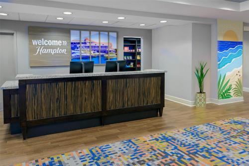 a lobby with a welcome bar in a hotel at Hampton Inn & Suites Pensacola/Gulf Breeze in Gulf Breeze