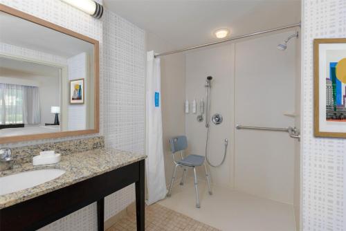 a bathroom with a shower and a sink and a shower at Hampton Inn & Suites Pensacola/Gulf Breeze in Gulf Breeze