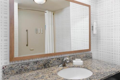 a bathroom with a sink and a mirror at Hampton Inn & Suites Pensacola/Gulf Breeze in Gulf Breeze