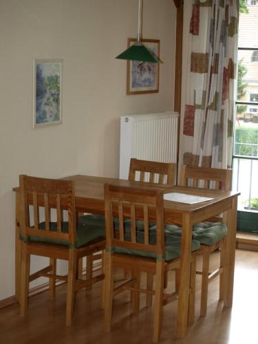 a dining room table with chairs and a table and a table and chairsktop at Apartment Alte Deckstation in Neustadt