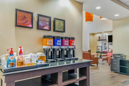 a lobby with a counter with bottles of alcohol at Hampton Inn & Suites Detroit/Airport Romulus in Romulus
