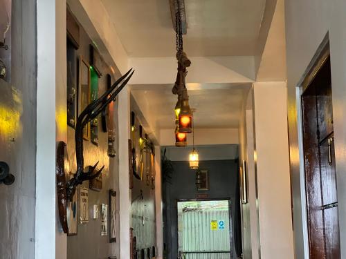 a hallway of a building with a chandelier hanging from the ceiling at Mount Ash Villa Hatton in Hatton