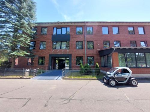a small car parked in front of a brick building at Wesendorf Residenz Premium Lounge in Wesendorf