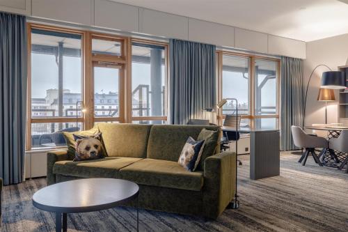 a living room with a couch and a table at Hilton Helsinki Strand in Helsinki