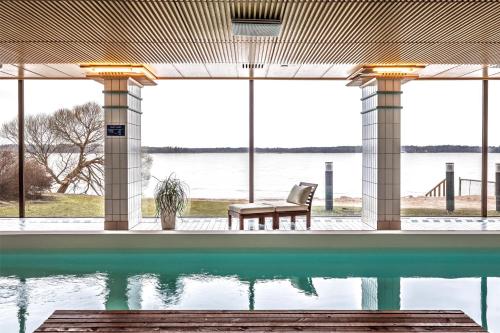 a swimming pool with a view of the water at Hilton Helsinki Kalastajatorppa in Helsinki