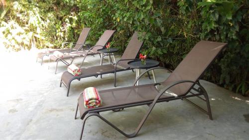 a row of empty chairs sitting on a beach at La Rana De Cahuita in Cahuita