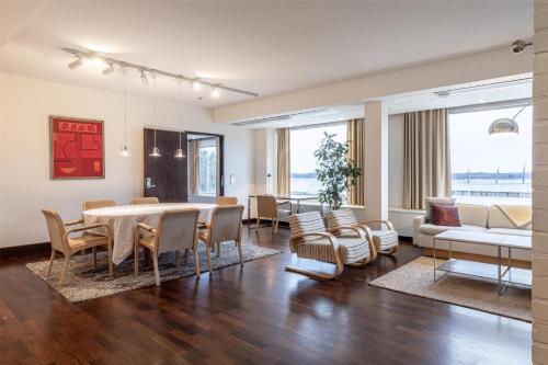 a living room with a table and chairs and a couch at Hilton Helsinki Kalastajatorppa in Helsinki