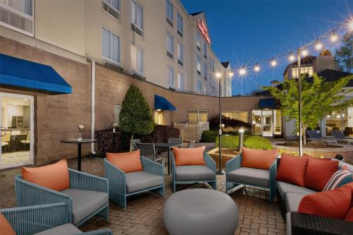 a patio with chairs and tables in front of a building at Hilton Garden Inn Huntsville/Space Center in Huntsville