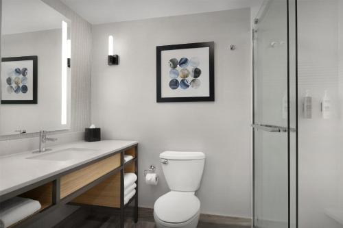a bathroom with a toilet and a sink and a shower at Hilton Garden Inn Huntsville/Space Center in Huntsville