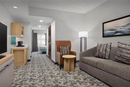 a living room with a couch and a table at Hilton Garden Inn Huntsville/Space Center in Huntsville