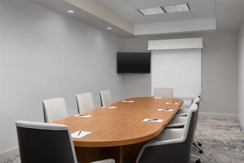 a conference room with a wooden table and chairs at Hilton Garden Inn Huntsville/Space Center in Huntsville