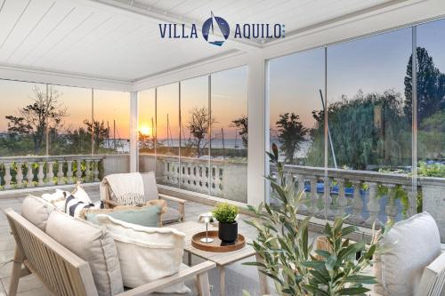 a living room with a view of the sunset at Aquilo Apartmanok in Tihany