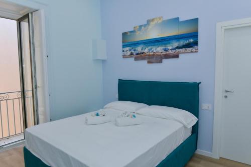 a bedroom with a bed with two towels on it at L'Aurora Azzurra -Luxury Suites Sorrento coast in Piano di Sorrento