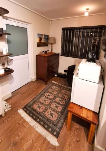 a living room with a door and a rug at 29 Cutty Sark in Plettenberg Bay