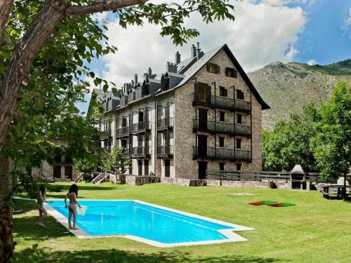 a woman standing next to a swimming pool in front of a building at Tu refugio cómodo y con piscina - Herbasabina 2 in Pla de l'Ermita