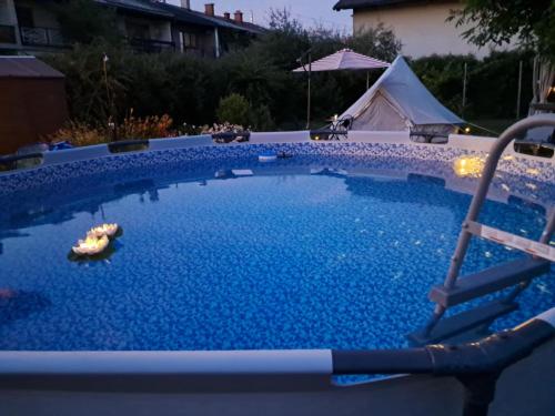 a swimming pool in a yard with a tent at ROSE Resort, ROOM 40m2 for 4 guests, with terrace in Ljubljana